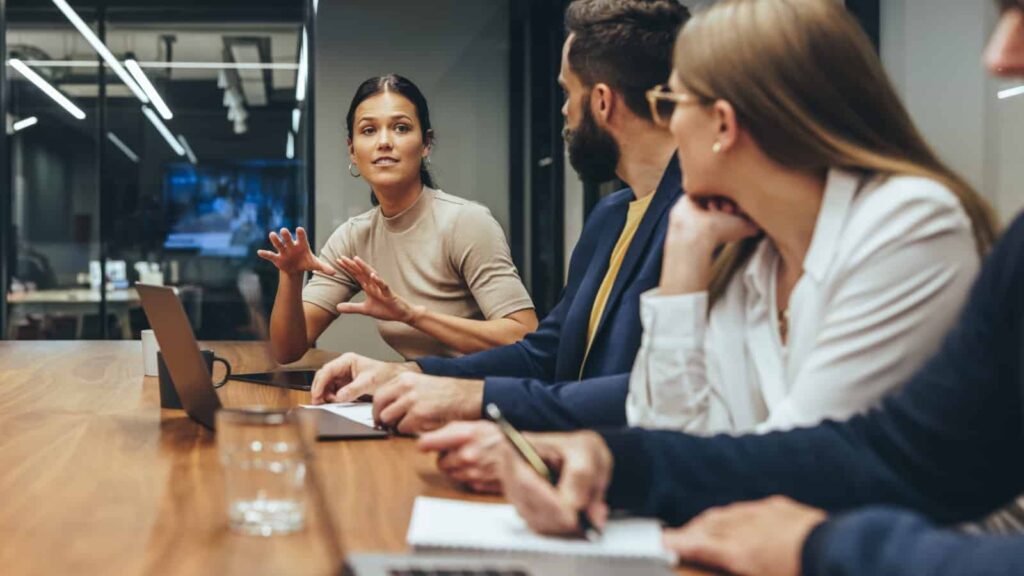 Meeting in conference room with woman in focus