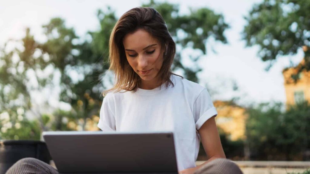 Woman working with laptop outside